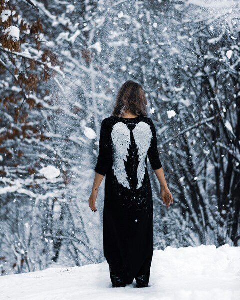 • Aesthetic Snowy Scene with Angel Winged Woman – 4K Wallpaper