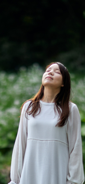 Aesthetic Nature Wallpaper – A Woman with Long Brown Hair in a White Dress